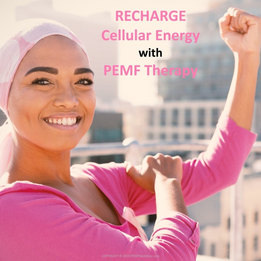 Vibrant smiling woman cancer survivor grabbing her flexed bicep muscle with her arm bent up and making a fist.  Recharge Cellular Energy with our PEMF therapy.